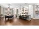 Spacious open-concept kitchen featuring a large island, stainless steel appliances, and dining area with wood floors at 506 Broadview Ne Pl, Atlanta, GA 30324