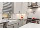 Well-lit kitchen with a farmhouse sink, subway tile backsplash, and stainless steel range at 506 Broadview Ne Pl, Atlanta, GA 30324