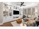 Modern living room with custom built-ins, neutral colors, ceiling fan, hardwood floors and abundant natural light at 506 Broadview Ne Pl, Atlanta, GA 30324