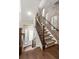 Entryway showcases a staircase with decorative carpet, wood trim, metal railing, brick accent wall, and natural light at 506 Broadview Ne Pl, Atlanta, GA 30324