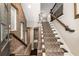 Entryway showcases a staircase with decorative carpet, wood trim, metal railing, brick accent wall, and natural light at 506 Broadview Ne Pl, Atlanta, GA 30324