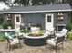 Outdoor fire pit surrounded by patio furniture, next to the house and pool at 5310 Lyndale Cir, Forest Park, GA 30297