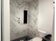 Stylish bathroom featuring a walk-in shower with marble-look tile and a built-in niche at 5310 Lyndale Cir, Forest Park, GA 30297