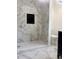Modern bathroom features marble-style tile walls, a walk-in shower, and a built-in niche at 5310 Lyndale Cir, Forest Park, GA 30297