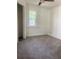 Cozy bedroom with soft gray carpet, ceiling fan, and a bright window at 5310 Lyndale Cir, Forest Park, GA 30297