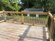 New wooden deck overlooking the yard, featuring black metal railings and post lights at 5310 Lyndale Cir, Forest Park, GA 30297