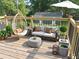 Well-appointed deck offers outdoor seating, a hanging chair, and decorative plants at 5310 Lyndale Cir, Forest Park, GA 30297