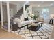 Staged living room showcasing modern furniture and decor, with a view of the staircase at 5310 Lyndale Cir, Forest Park, GA 30297