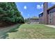 Large, level backyard features a lush lawn and mature trees offering privacy at 5485 Sandstone Ct, Cumming, GA 30040
