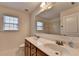 Bathroom with double sinks, vanity, and a well-lit mirror at 5485 Sandstone Ct, Cumming, GA 30040