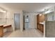 This bathroom features double sinks, vanity and a step in shower with glass doors at 5485 Sandstone Ct, Cumming, GA 30040