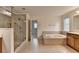 Bathroom showcasing a large soaking tub and glass shower at 5485 Sandstone Ct, Cumming, GA 30040