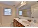 Bathroom with double sinks, vanity, and a well-lit mirror at 5485 Sandstone Ct, Cumming, GA 30040
