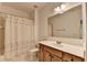 Bathroom features a shower/tub combo, a vanity with ample storage, and a large mirror at 5485 Sandstone Ct, Cumming, GA 30040