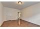This bedroom features wood floors, white walls, and two doors; one leading to a closet and the other to the hallway at 5485 Sandstone Ct, Cumming, GA 30040