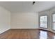 Large bedroom featuring hardwood floors, neutral walls, and abundant natural light at 5485 Sandstone Ct, Cumming, GA 30040