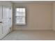 Empty bedroom with carpet, neutral walls, and a window bringing in natural light at 5485 Sandstone Ct, Cumming, GA 30040