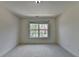 Well-lit bedroom showcasing a view of the neighborhood at 5485 Sandstone Ct, Cumming, GA 30040