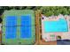 Aerial view of the community pool and tennis courts, perfect for active residents and social gatherings at 5485 Sandstone Ct, Cumming, GA 30040