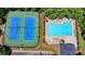 Aerial view of the community pool and tennis courts, perfect for summer fun and recreation at 5485 Sandstone Ct, Cumming, GA 30040