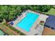 Aerial view showcasing the expansive community pool with plenty of lounging space and lush surroundings at 5485 Sandstone Ct, Cumming, GA 30040