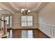 Formal dining room with hardwood floors, wainscoting, and chandelier lighting at 5485 Sandstone Ct, Cumming, GA 30040