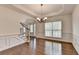 Bright dining room with hardwood floors, wainscoting, and large windows at 5485 Sandstone Ct, Cumming, GA 30040