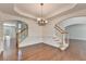 Open dining room with hardwood floors, decorative molding, and staircase at 5485 Sandstone Ct, Cumming, GA 30040