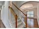 Bright entryway featuring wood floors, an arched entry, a staircase with carpet, and a view of the dining room at 5485 Sandstone Ct, Cumming, GA 30040