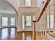 Elegant foyer featuring hardwood floors, a staircase with white railings, and a front door with sidelights at 5485 Sandstone Ct, Cumming, GA 30040