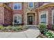 Charming front entrance with stone accents, manicured landscaping, and a welcoming doorway at 5485 Sandstone Ct, Cumming, GA 30040
