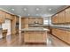 Spacious kitchen with hardwood floors, central island with granite countertop, and stainless steel appliances at 5485 Sandstone Ct, Cumming, GA 30040