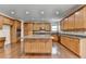 Beautiful kitchen with hardwood floors, a granite countertop island, wooden cabinets, and stainless steel appliances at 5485 Sandstone Ct, Cumming, GA 30040