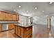This kitchen features granite countertops, stainless steel appliances, a center island, and a large adjacent living space at 5485 Sandstone Ct, Cumming, GA 30040