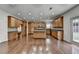 Large kitchen with wood cabinets, central island with granite countertop and stainless steel appliances at 5485 Sandstone Ct, Cumming, GA 30040