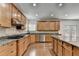 Spacious kitchen featuring granite countertops, wood floors, stainless steel appliances, and ample cabinet space at 5485 Sandstone Ct, Cumming, GA 30040