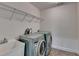 Laundry room featuring a washer, dryer, utility sink and overhead shelving at 5485 Sandstone Ct, Cumming, GA 30040