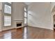Spacious living room featuring hardwood floors, a fireplace, and tall windows at 5485 Sandstone Ct, Cumming, GA 30040