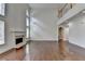 Bright living room with hardwood floors, a fireplace and an abundance of natural light from large windows at 5485 Sandstone Ct, Cumming, GA 30040