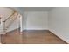 Open living space with hardwood floors, staircase access, and ample natural light at 5485 Sandstone Ct, Cumming, GA 30040