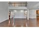 Spacious living room with hardwood floors, natural light and open floor plan with stairs to the second floor at 5485 Sandstone Ct, Cumming, GA 30040