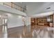 Expansive living room with open floor plan, hardwood floors, and access to the kitchen at 5485 Sandstone Ct, Cumming, GA 30040