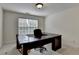 Office with a large desk, neutral carpet and a window bringing in natural light at 5485 Sandstone Ct, Cumming, GA 30040