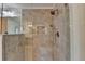 Step in shower features grey tile surround, overhead shower head and glass door at 5485 Sandstone Ct, Cumming, GA 30040