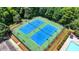 Aerial view of community tennis courts ready for a match, perfect for active residents and social gatherings at 5485 Sandstone Ct, Cumming, GA 30040