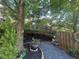Lush backyard featuring mature trees, decorative mulch, and stone landscaping accents creating a tranquil outdoor space at 127 Spring Way Sq, Canton, GA 30114