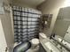 Charming bathroom featuring blue-striped shower curtain, granite countertop, and well-organized storage at 127 Spring Way Sq, Canton, GA 30114