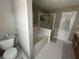 Bathroom area featuring a bathtub and glass shower at 127 Spring Way Sq, Canton, GA 30114