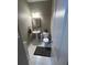 Half bath features a pedestal sink, toilet, decorative mirror, and neutral color scheme at 127 Spring Way Sq, Canton, GA 30114