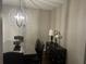 Dining room features a decorative chandelier, wall decor, and dark wood table set, creating an elegant space at 127 Spring Way Sq, Canton, GA 30114